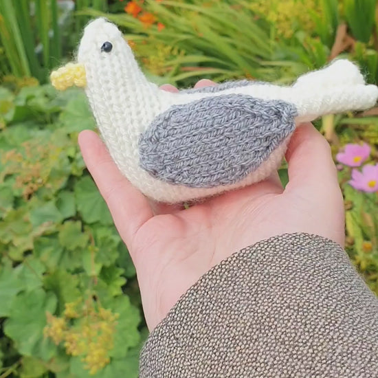 a knitted seagull in a Scottish garden