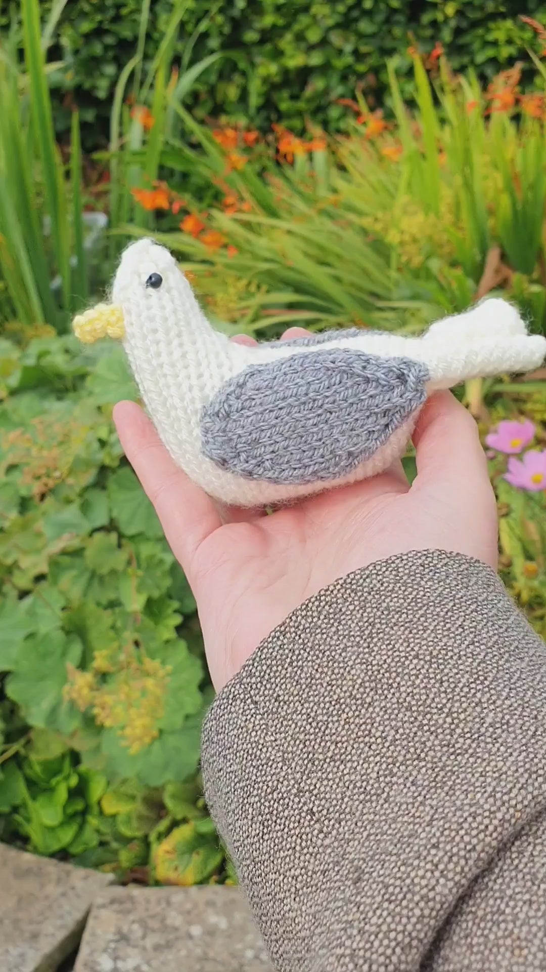 a knitted seagull in a Scottish garden