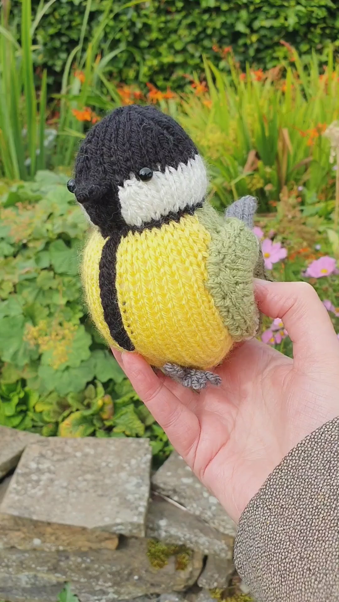a knitted great tit in a Scottish garden